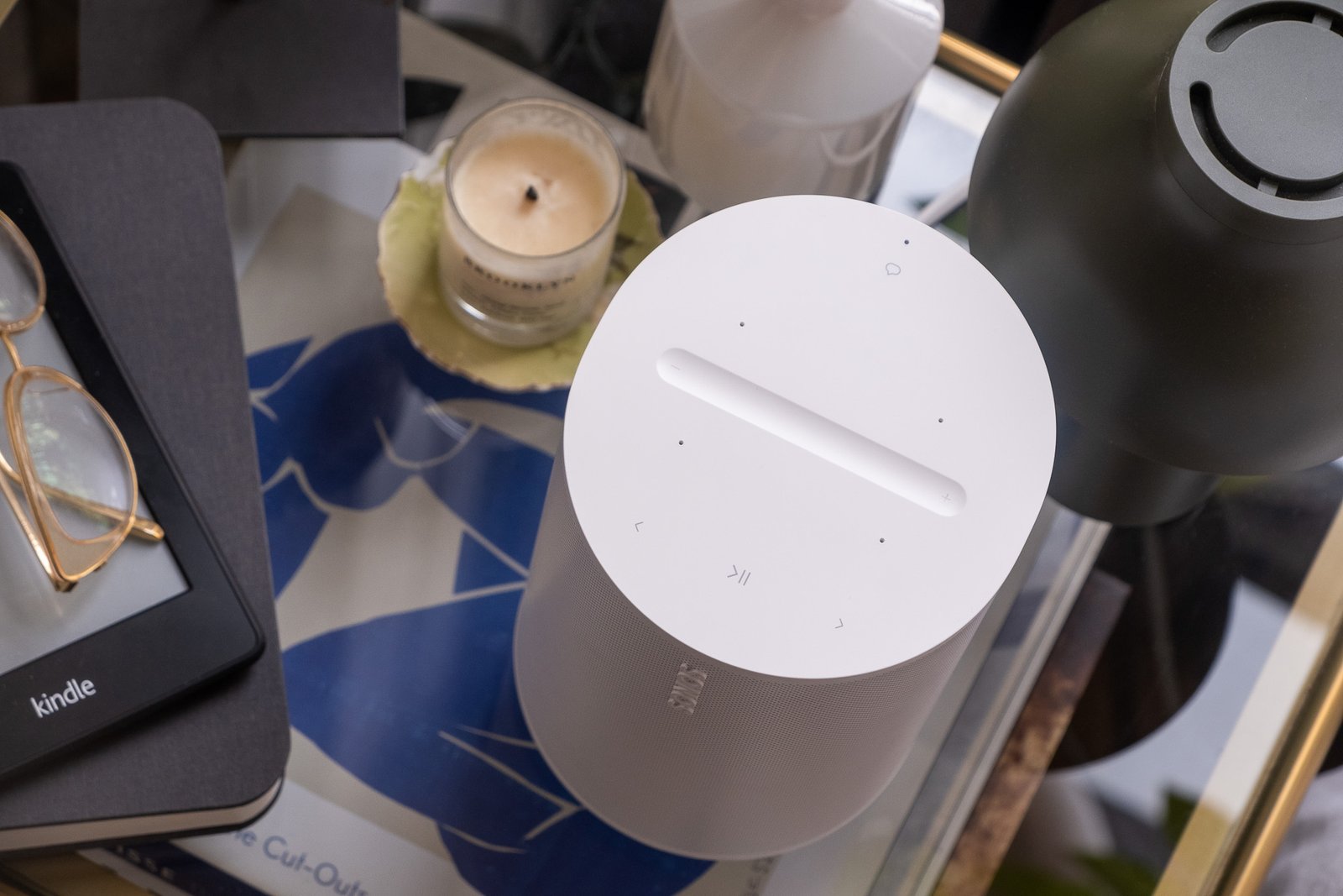 A photo of the Sonos Era 100 on a bedside nightstand.