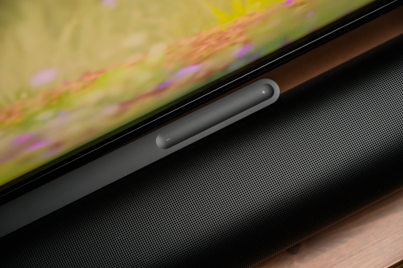 A photo of the Sonos Arc Ultra soundbar in front of a television on a stand.