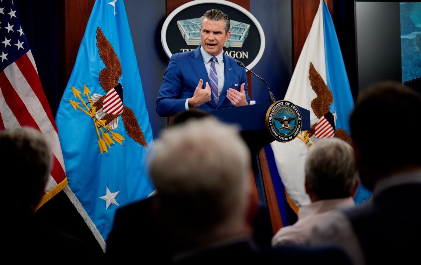US Defense Secretary Pete Hegseth speaks at a podium during a news conference.