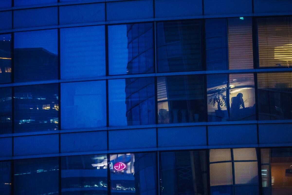 Apartment buildings light up in the evening as people return home from work in Seoul
