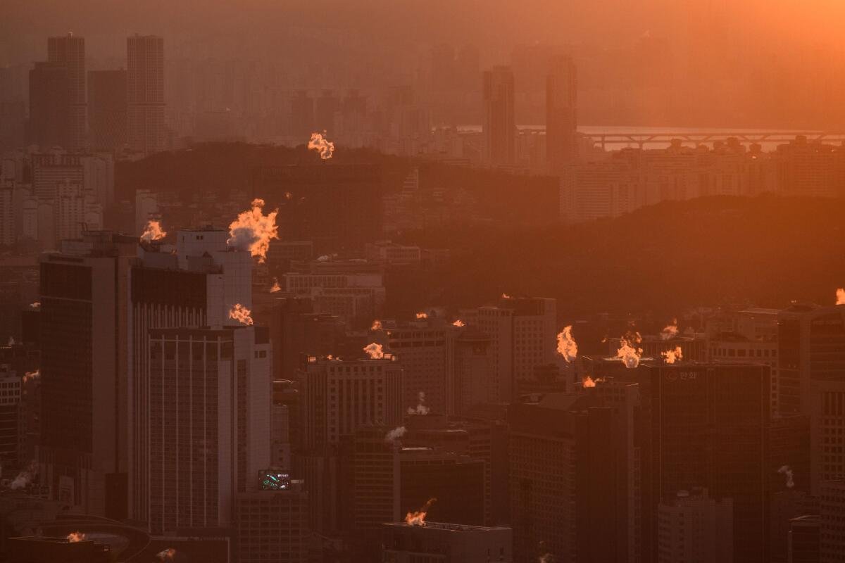 A general view shows steam rising from office and apartment buildings that define the Seoul skyline.