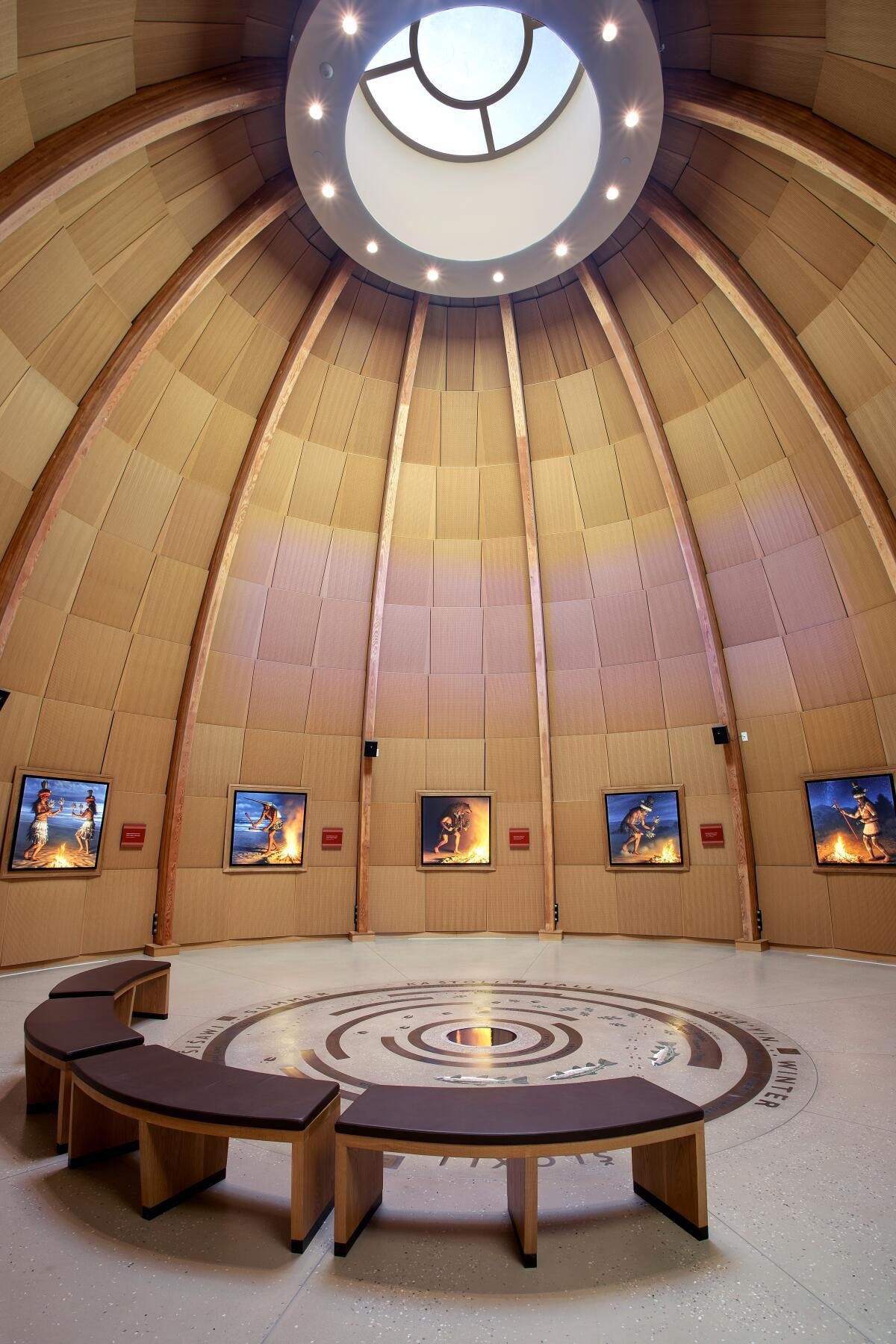 A giant "ap" featuring curving ribbed walls and a round skylight at the Santa Ynez Chumash Museum.