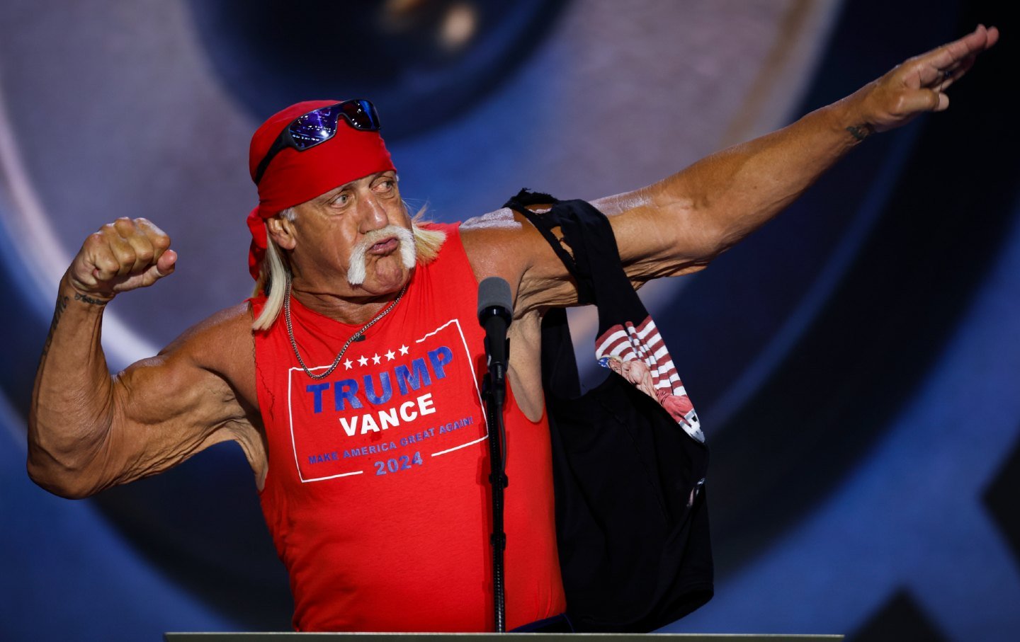 Wrestler Hulk Hogan poses in a cut-off T-shirt in support of Donald Trump's second presidential campaign.