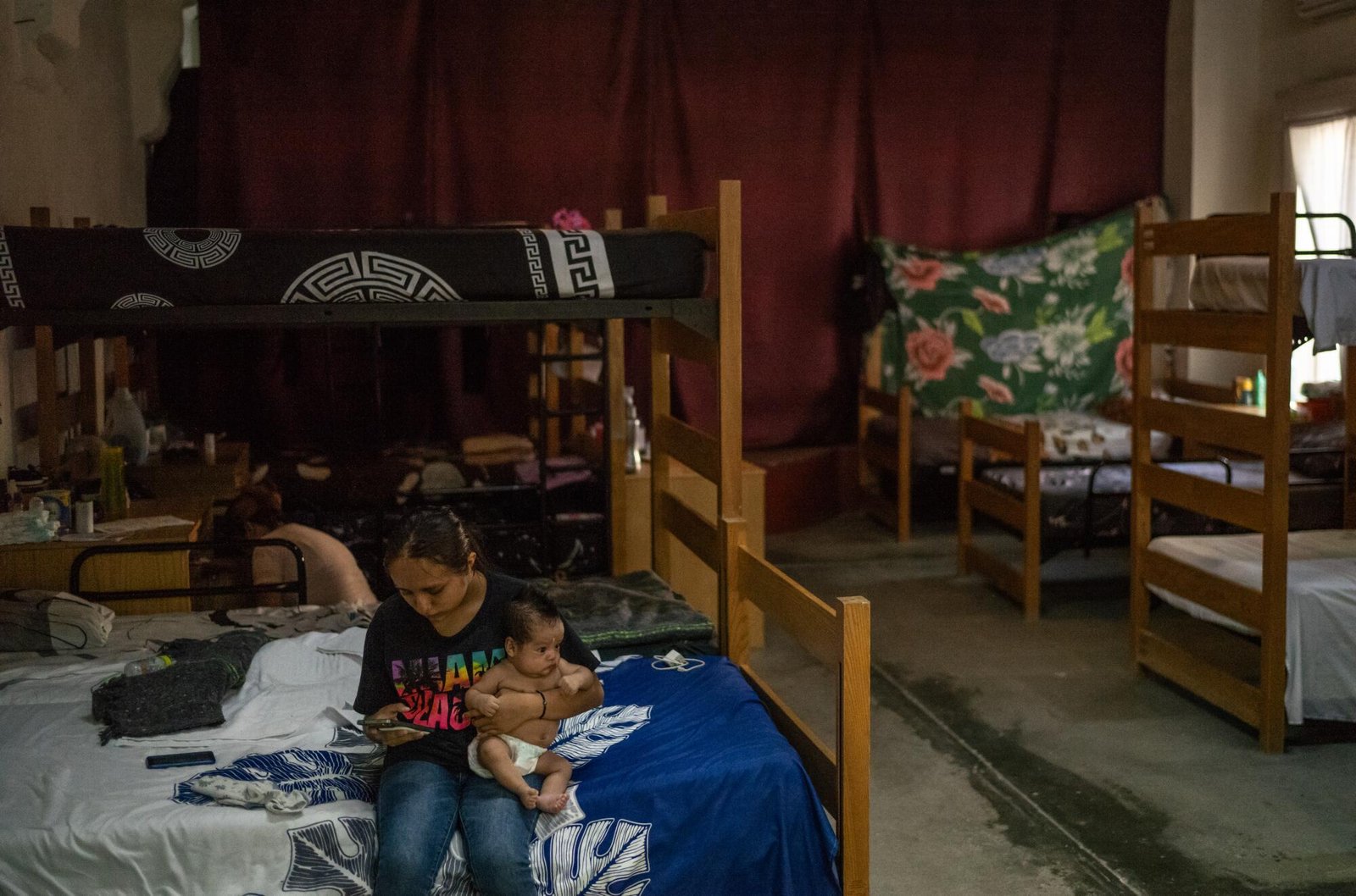A migrant holds her child at Oasis del Migrante shelter
