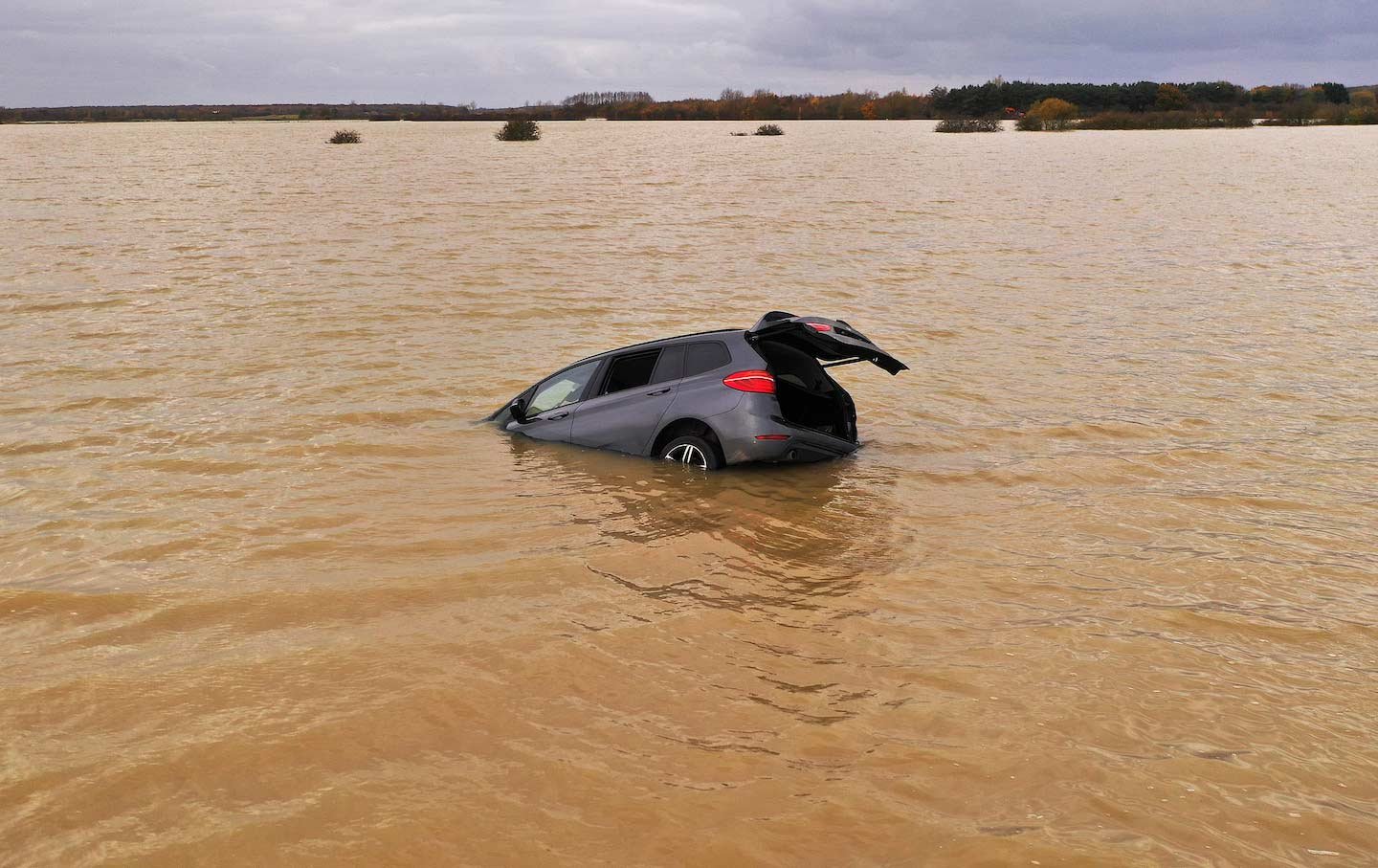 A car is seen part submerged in floodwater in England, 2019.