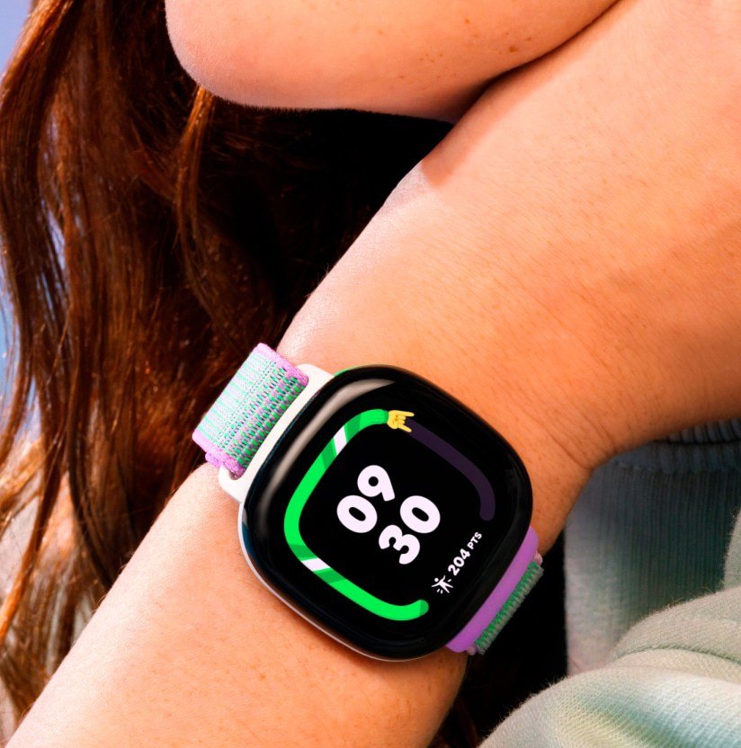 A close-up image of a teenage girl wearing the Fitbit Ace LTE on her wrist.