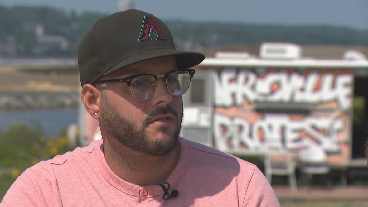 Eddy Carvery III, Eddie Carvery's grandson, stands in front of his grandfather's trailer in Africville Park.