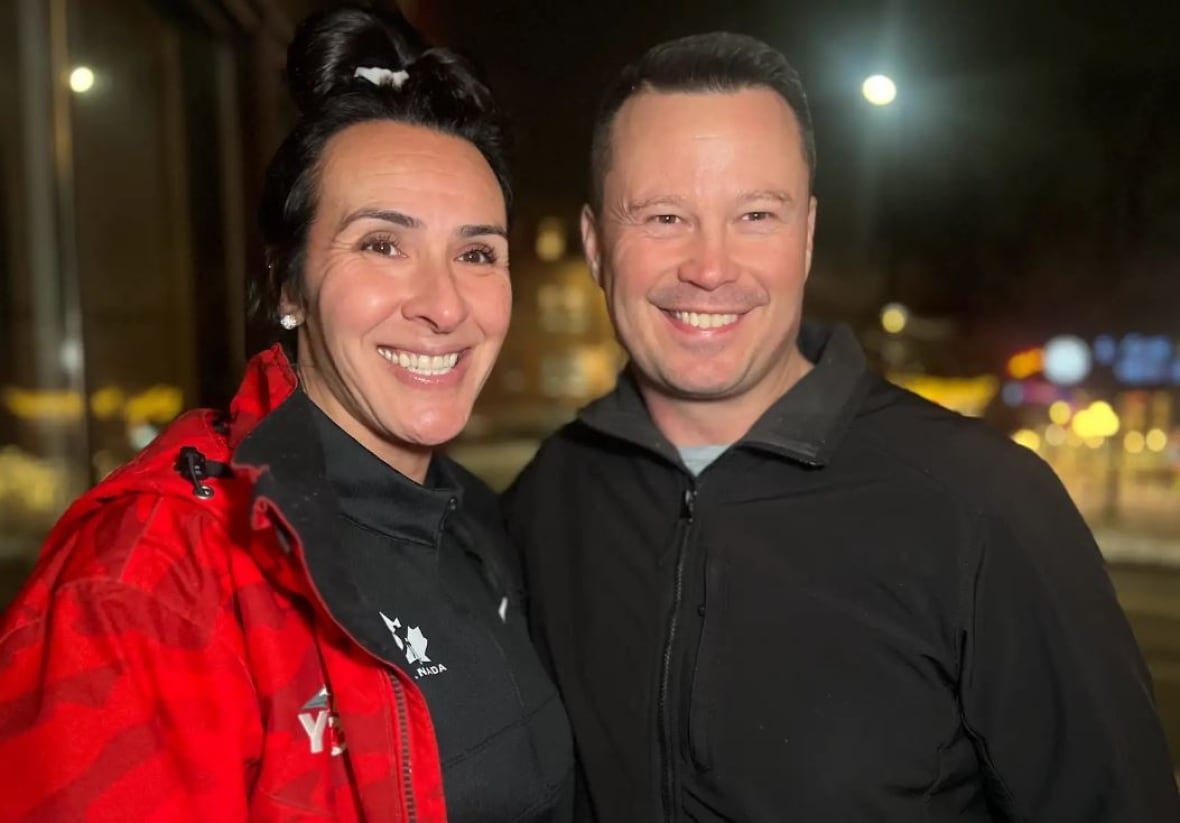 A woman in a red jacket and a man in a black jacket.