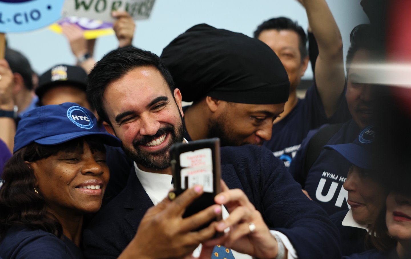 Zohran Mamdani takes photos with supporters during a press conference at the Hotel & Gaming Trades Council building on July 02, 2025, in New York City.