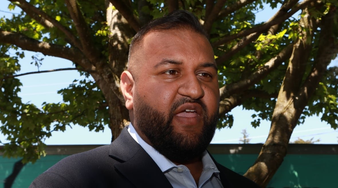 A man talks outdoors.