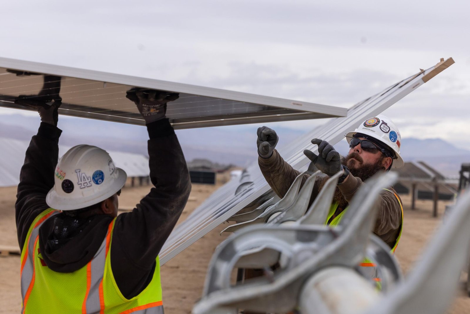 Workers install solar panels for the Los Angeles Department of Water and Power's Eland Solar and Storage Center 