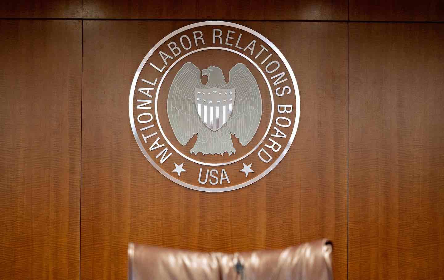 The National Labor Relations Board seal hangs inside a hearing room at the headquarters in Washington, DC.