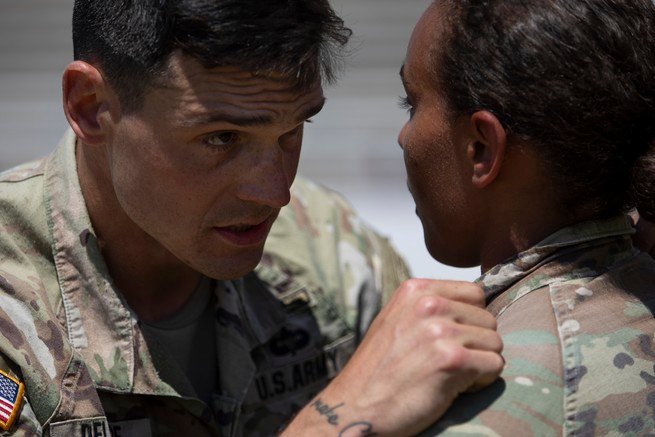 Teammates Capt. Seth Deltenre and First Lt. Gabrielle White discuss a plan between events during the Best Ranger Competition at Fort Benning in Columbus, Georgia April 12, 2025.