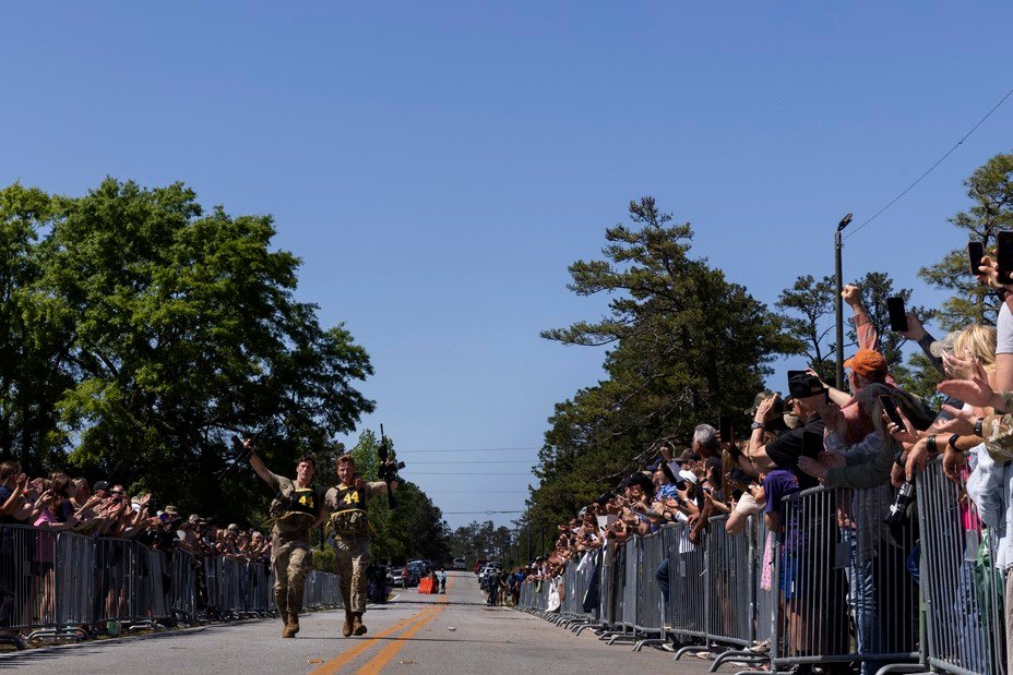 1st Lt. Kevin Moore (left) and 1st Lt. Griffin Hokanson, from the 75th Ranger Regiment, run to cross the finish line at the end of the Best Ranger Competition 