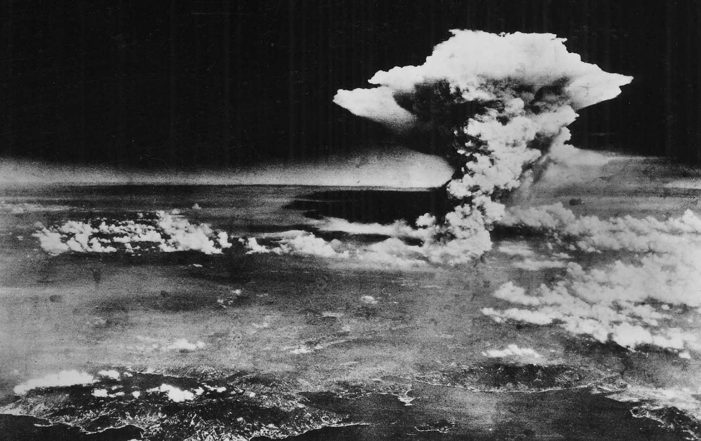 A huge cloud resulting from the massive fires started by “Little Boy,” the atomic bomb dropped on Hiroshima, Japan, is photographed from a reconnaissance plane a few hours after the initial explosion on August 6, 1945.