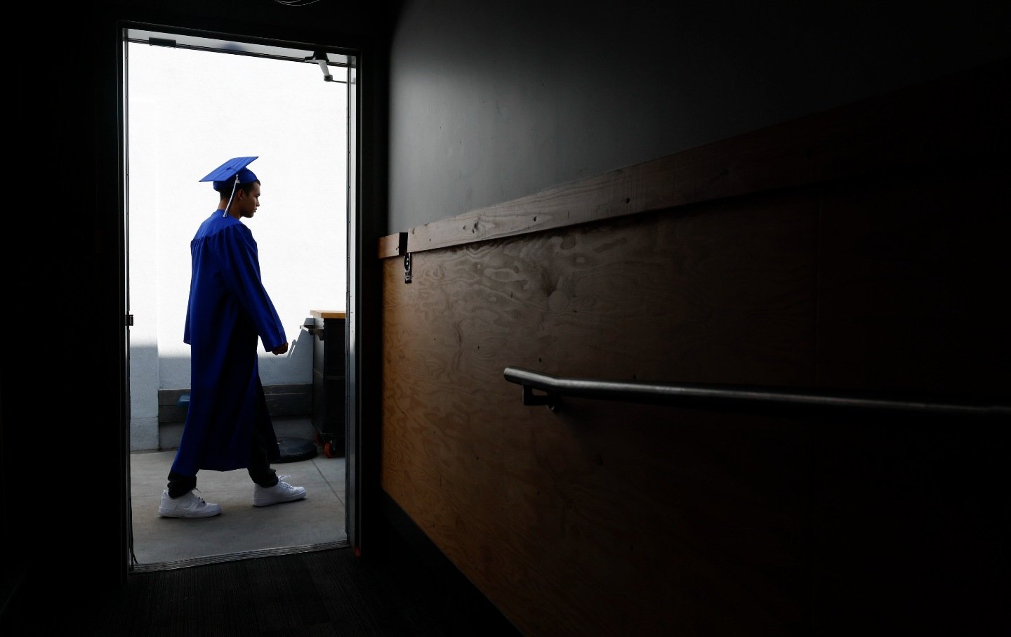 A student walks towards the entrance of their graduation ceremony in Los Angeles, California.