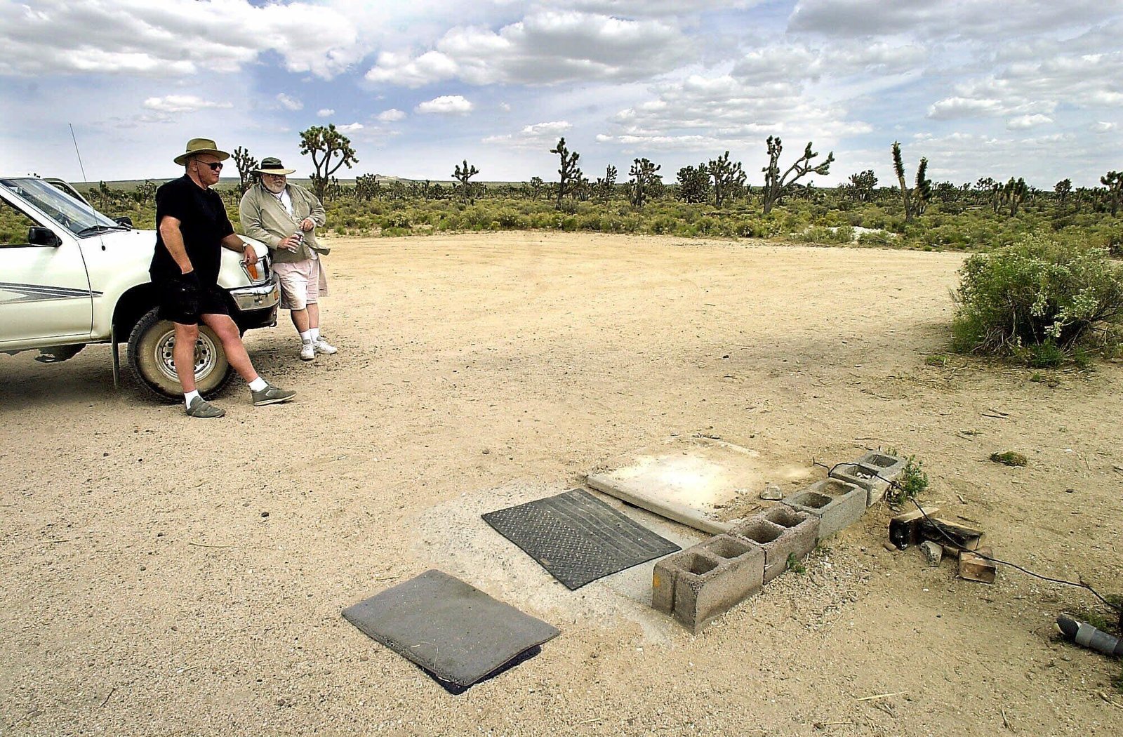 James Wielenga, left, and Gerald Zettel at spot where the so–called Mojave Phone Booth formerly stood Friday, May 19, 2000.