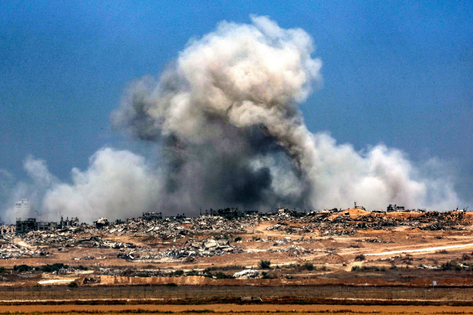 A plume of smoke erupts during Israeli bombardment in the Gaza Strip as pictured from across the border in southern Israel