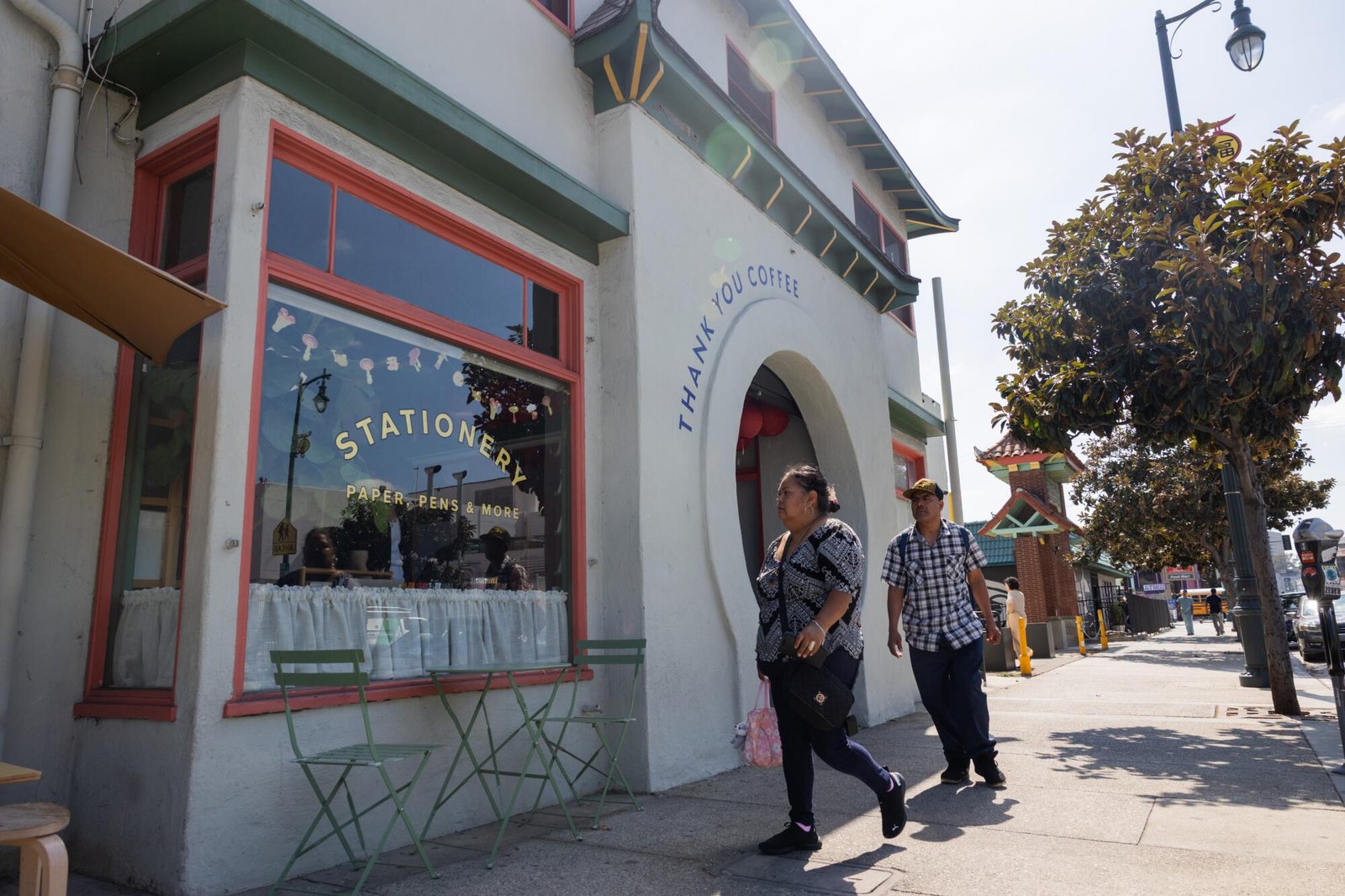Guests walk past a Chinatown storefront. 