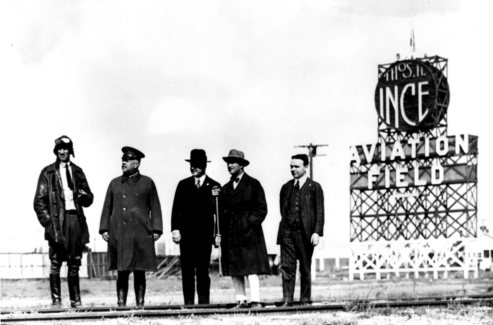 Men stand at Thomas Ince airfield at Venice Boulevard and Mildred Avenue.