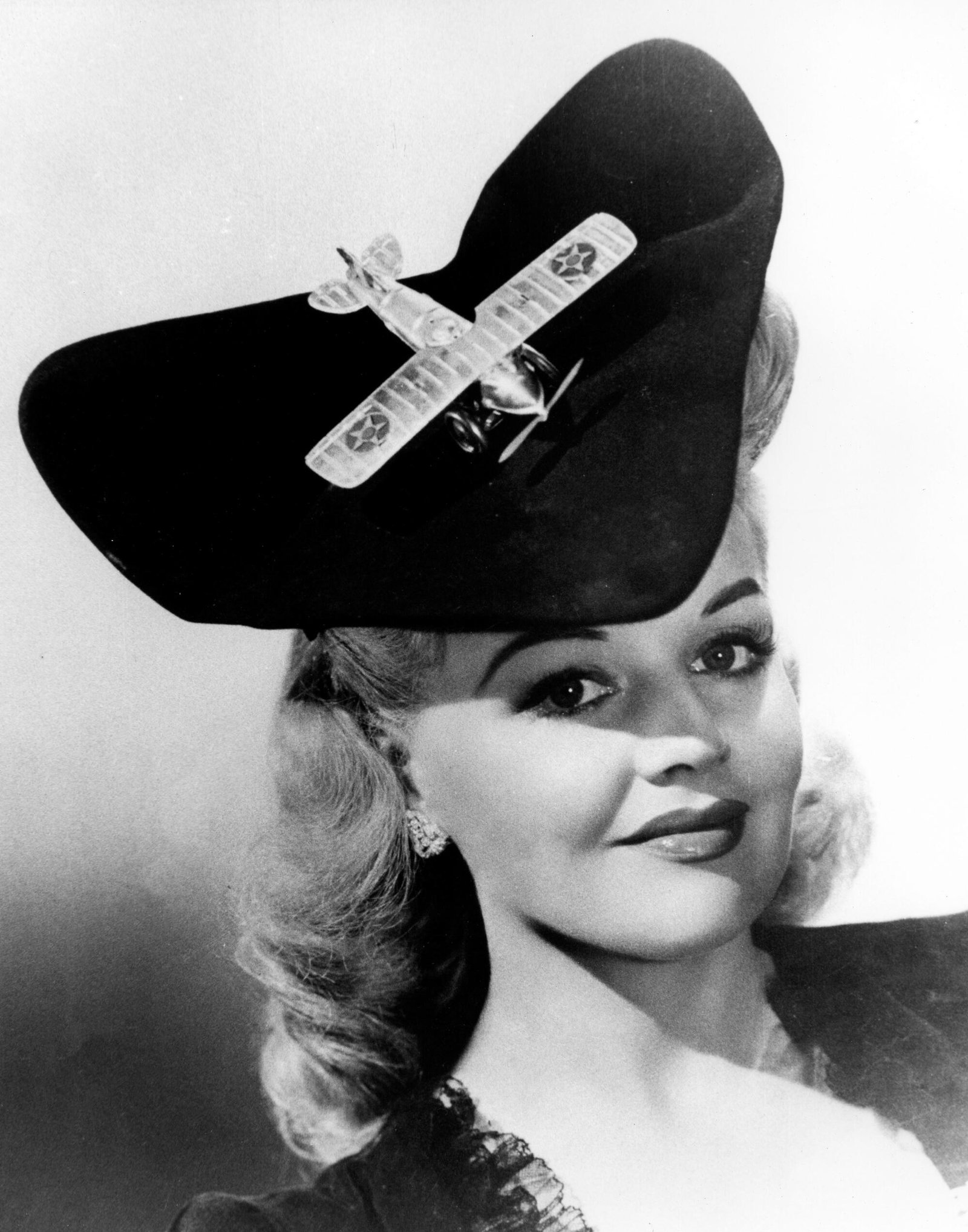 A woman with an airplane hat in the 1940s.